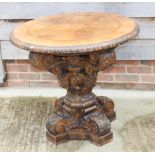 A late 19th Century Central European carved walnut and inlaid circular table of Renaissance