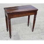 A 19th Century mahogany fold-over top card table, on circular baize, 32" wide