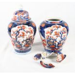 A pair of Imari oviform jars and covers (one cover damaged), 13" high, and a pair of Imari vases (