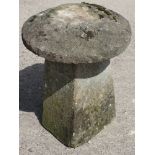 A staddle stone base with later cast cap