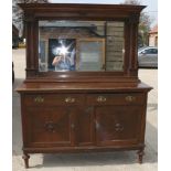 An early 20th Century oak sideboard with mirrored canopy back, base fitted two drawers and