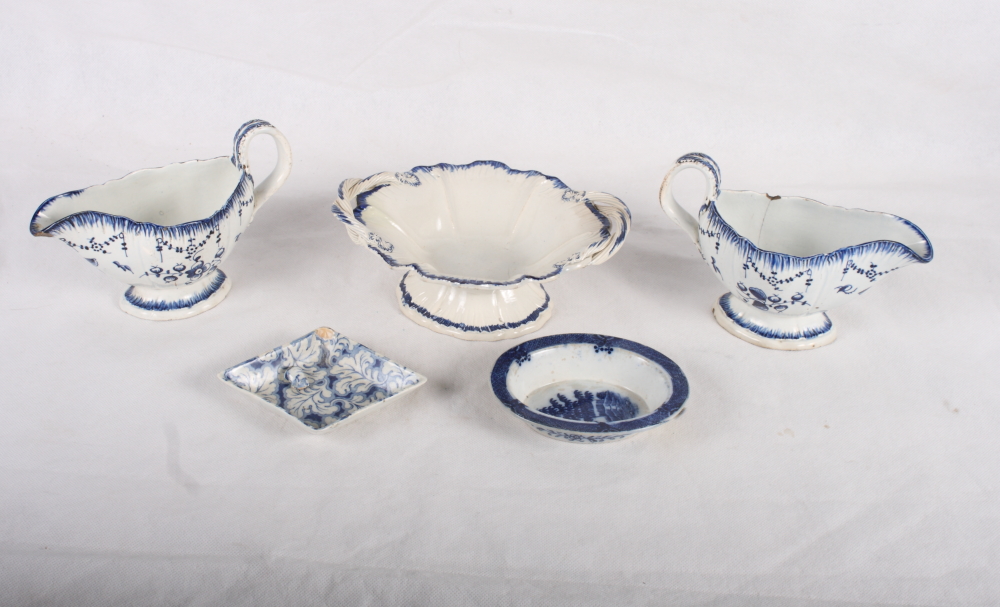 A pair of 18th Century blue and white sauceboats, sides painted flowers, a similar oval two-