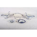 A pair of 18th Century blue and white sauceboats, sides painted flowers, a similar oval two-