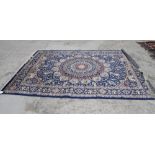 A Kashan design rug decorated central circular medallion on a blue ground with main border stripe