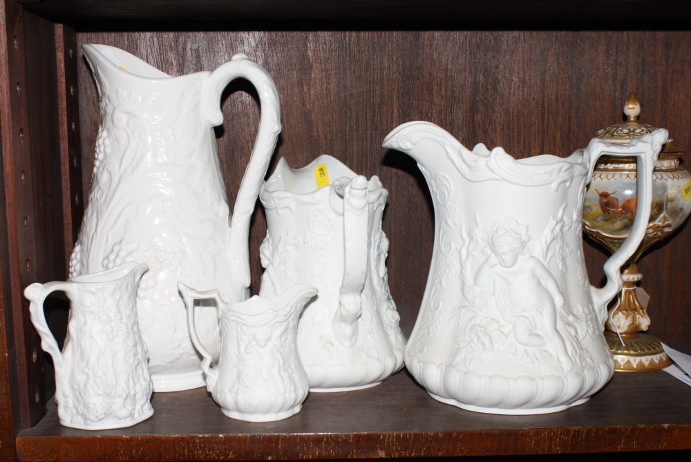 A Portmeirion Parian ware jug, sides moulded cherubs, 7" high, three similar smaller jugs and a