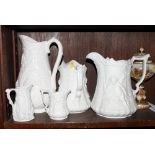 A Portmeirion Parian ware jug, sides moulded cherubs, 7" high, three similar smaller jugs and a