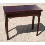 A Georgian design mahogany fold-over top card table with plain frieze, on square chamfered supports,
