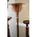 A French Art Deco copper uplighter decorated frosted glass panels on circular stepped base