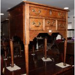 An 18th Century oak lowboy, fitted one long and three deep drawers, on turned supports, 29" wide