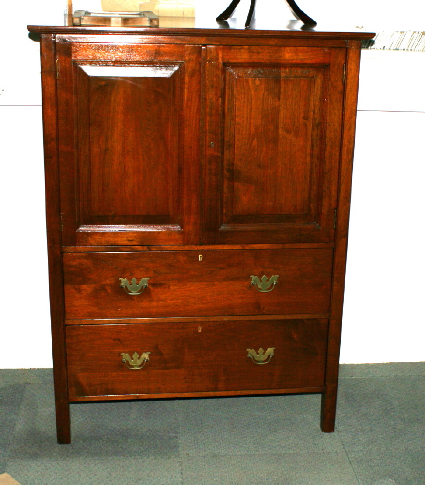 A polished as mahogany cupboard enclosed two doors, fitted two drawers below, 36" wide