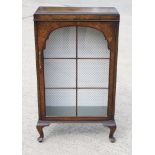 An early 20th Century figured walnut pedestal display cabinet, on cabriole supports, 24" wide