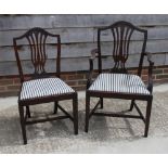 A set of eight polished as mahogany dining chairs with pierced central splats, drop-in seats, on