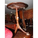 A 19th Century mahogany circular occasional table, on vase turned stem and tripod base, 19" dia