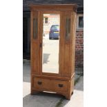 An Edwardian mahogany wardrobe enclosed panelled doors, on bracket supports, 40" wide