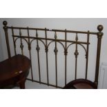 An early 20th Century brass rail bed head and an oval wall mirror