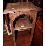 An oak square two-tier occasional table, on square supports carved leaves, and another square leaf