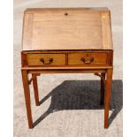 A 20th Century mahogany bureau, fitted two drawers, on square supports, 30" wide