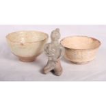 A collection of early Chinese provincial pottery bowls, jars and a kneeling figure
