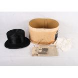 A black silk top hat from Battersby & Co, in original box, and a cream silk evening scarf