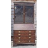 A Georgian oak bureau bookcase, the upper section enclosed two astragal beaded glazed doors, over