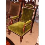 A late Victorian walnut showframe open armchair, upholstered in a green velour, on turned supports