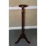 A 19th Century mahogany torchere, on spiral turned stem and tripod base