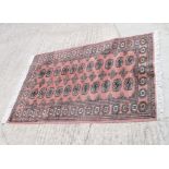 A Bokhara mat decorated twenty-two guls, 57" x 37" approx