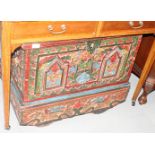 An Indonesian carved hardwood and painted wheeled wedding chest with part fitted interior, 30" wide