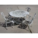 A white painted cast aluminium circular garden table, 42" dia, and a set of four chairs