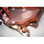 A Victorian mahogany shape front writing table with inlet leather top, on scroll carved paw feet,