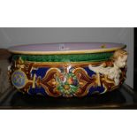 A mid 19th Century Renaissance revival majolica bowl with cherub head handles and relief decoration,