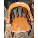 A captain's spindle back elbow chair