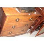 An early 20th Century oak dressing chest fitted oxidised copper knobs