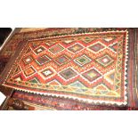 A kelim rug with banded decoration in shades of red, orange, yellow and green, 108" x 53" approx