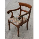 A 19th Century mahogany scroll arm library chair, upholstered in a Florentine stitch fabric, on