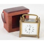 A French brass and glass cased carriage clock, in travel case, 4 1/2" high