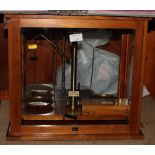 A late Victorian Avery portable balance in burr walnut case and a chemist's laboratory balance in