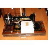 A Frister & Rossman portable sewing machine, in case with accessories and paperwork