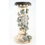 A 19th Century stoneware jardiniere stand with relief decoration and coat of arms said to have