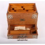 An early 20th Century oak stationery holder with pierced plated mounts