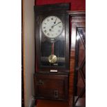 A 1920s oak cased clocking-in clock by the Gledhill Brook Time Keeping Company Huddersfield