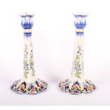 A pair of Mosanic French faience floral decorated candlesticks, 9 1/2" high and a jar cover formed