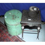 A pierced metal footman on wrought iron supports, a green painted metal hat box and a cast iron