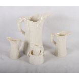 A set of four Royal Worcester china leaf moulded jugs, in sizes, largest 8" high, a similar two-