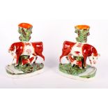 A pair of Staffordshire cow and calf spill holders, 11" high