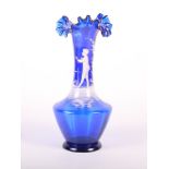 A Victorian blue glass vase with frilled top and "Mary Gregory" decoration, 10" high