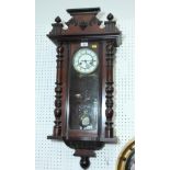 A Victorian wall clock in polished as mahogany case decorated split turned pilasters