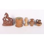 A brown salt glazed pepperette moulded as Queen Anne, two smaller similar jugs, a tobacco jar and