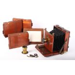 A late 19th Century mahogany plate camera with accessories to include a brass lens by Talco London