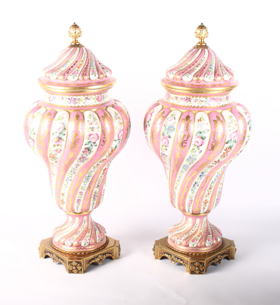 A pair of Paris porcelain vases and covers, the spiral fluted bodies with floral and gilt decoration